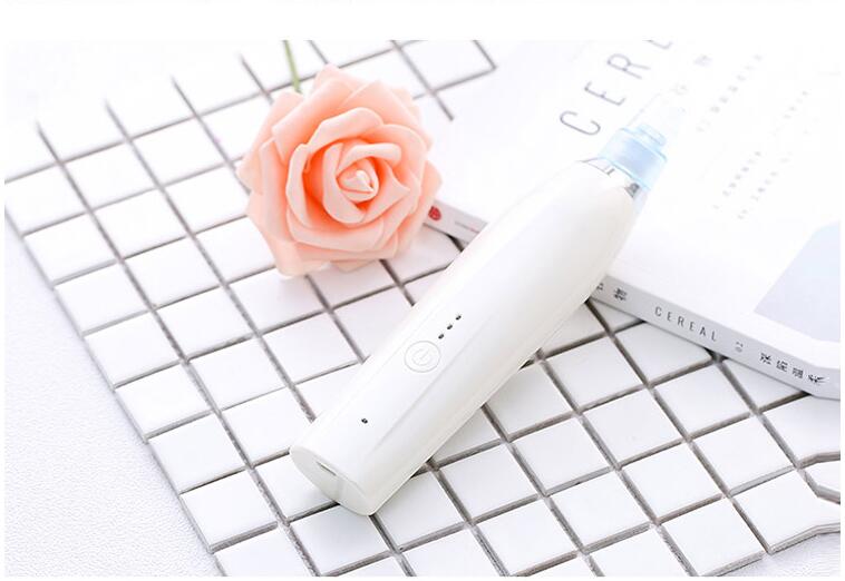 Darziq Acne Blackhead Suction Remover in black, showing its handheld device with a rounded metal tip for pore extraction.
