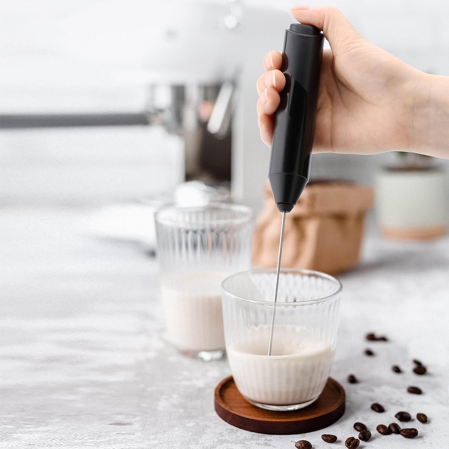 Darziq electric milk frother for home and kitchen, showing frothing whisk and stainless steel body on a countertop.